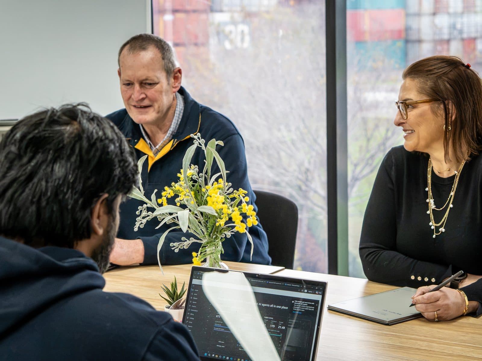 Three SCCS team members in a review meeting at the Port Melbourne office